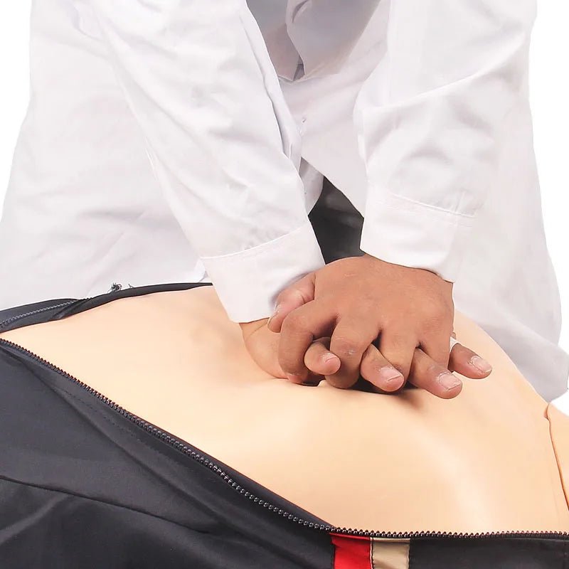Medical Health Care CPR Simulator & Artificial Respiration Training Dummy Picture in use with 2 crossed hands pushing on the dummy chest.