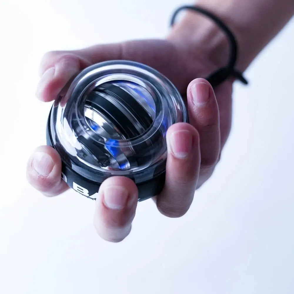 Fitness Gyroscopic Powerball Muscle Trainer Black Colour Ball shown in use by a man right hand