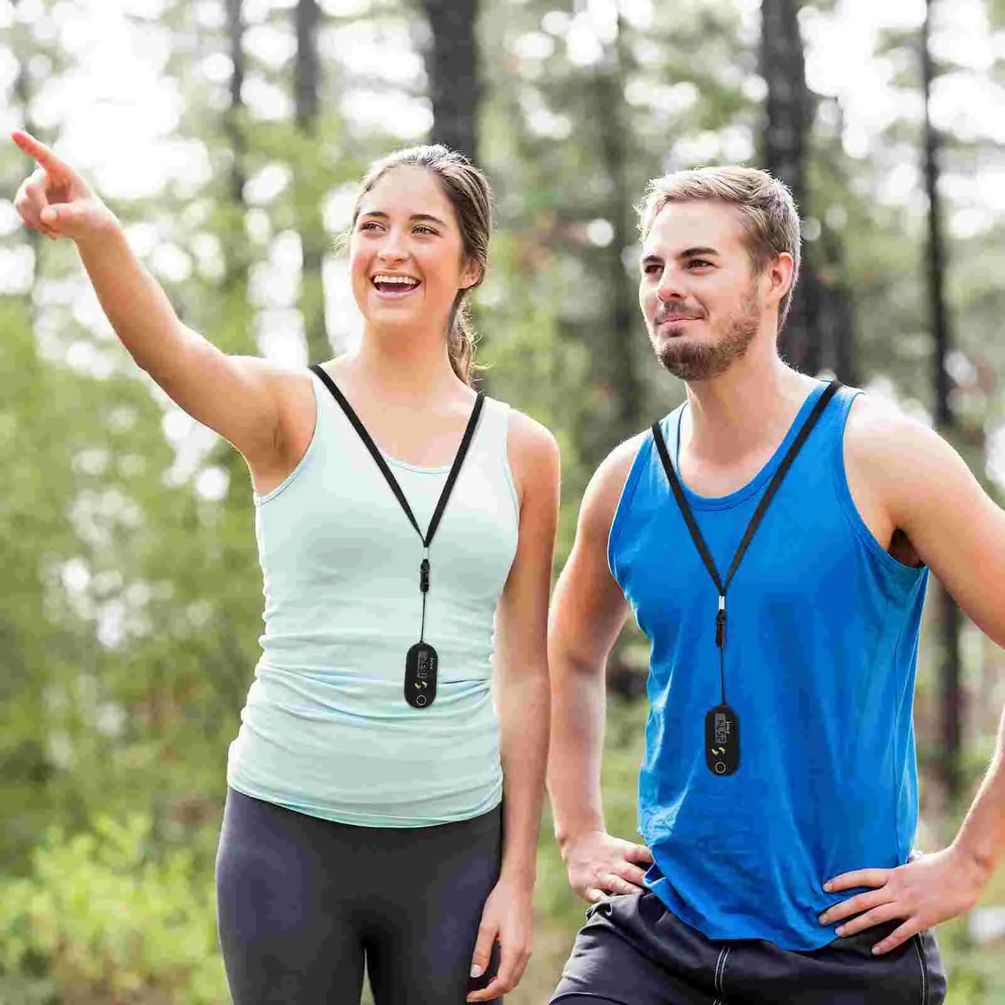 Fitness Sport Digital Portable Run Step Pedometer wear in neckless by a couple Man with blue T-shirt and the young woman with a white T-shirt in the forest