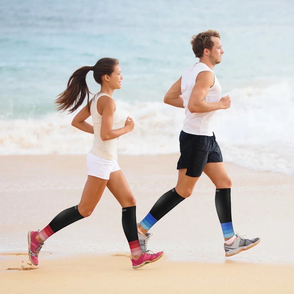 Fitness Unisex Compression Sleeves 20-30 mm Hg Running Leg Socks wear by a couple running at the beach