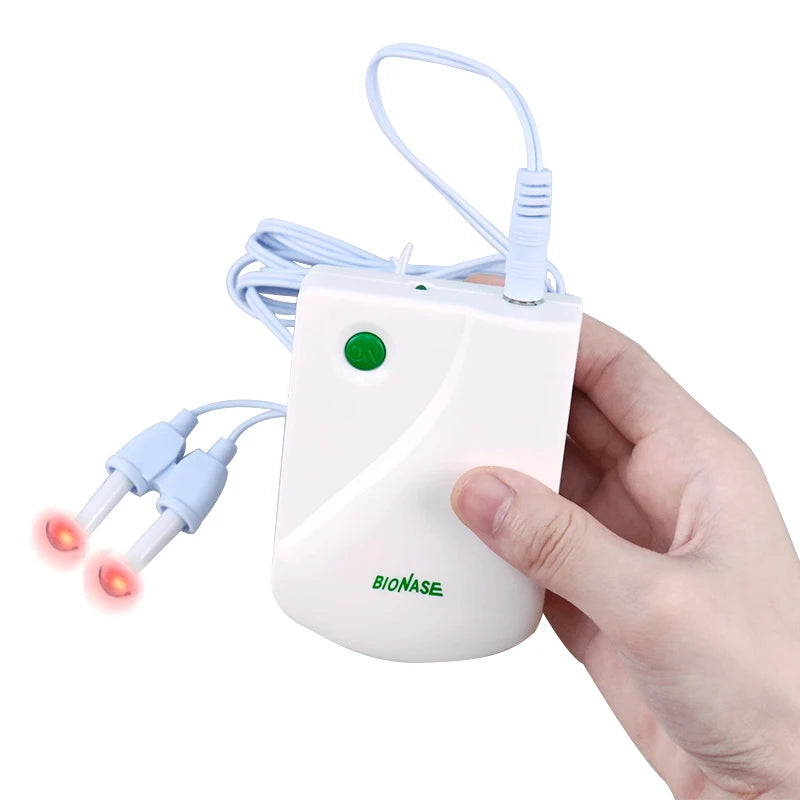 Health care products Nose therapy Massage Pulse Laser with USB cable in use by a woman hand