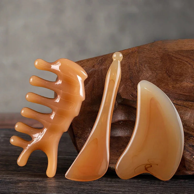 Massage Therapy Facial Massager Scraping Resin 3 pieces set offers shown on an eco-friendly teak table