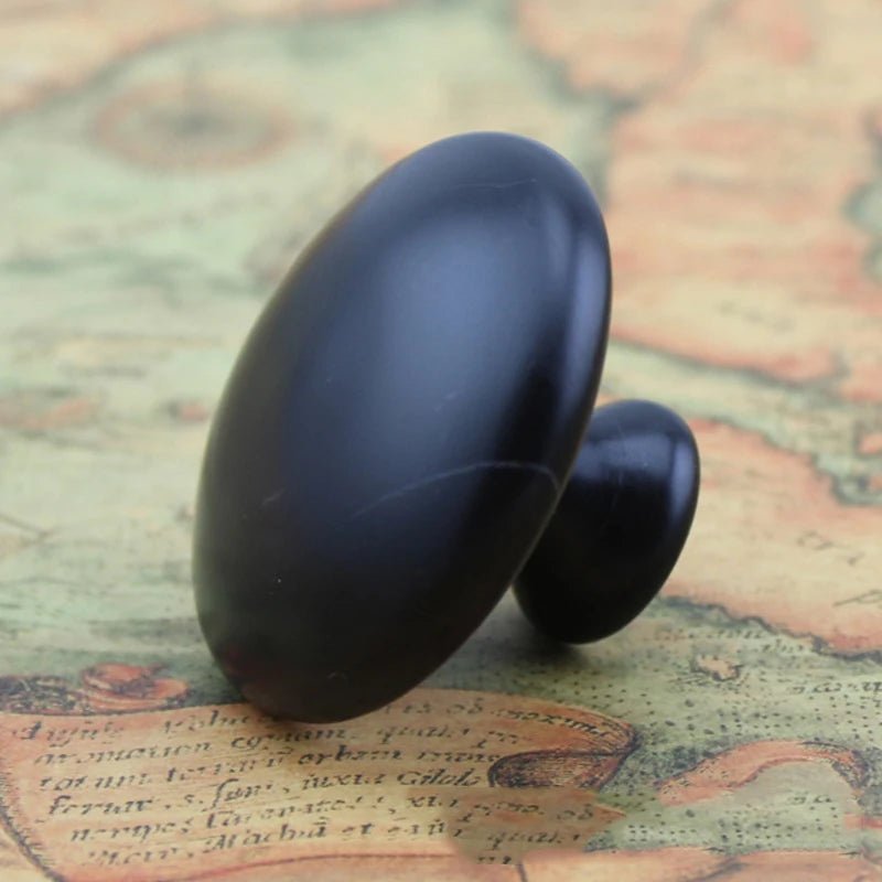 Massage Therapy Handmade Black Basalt Mushroom Stone Massager with old fashion map in background
