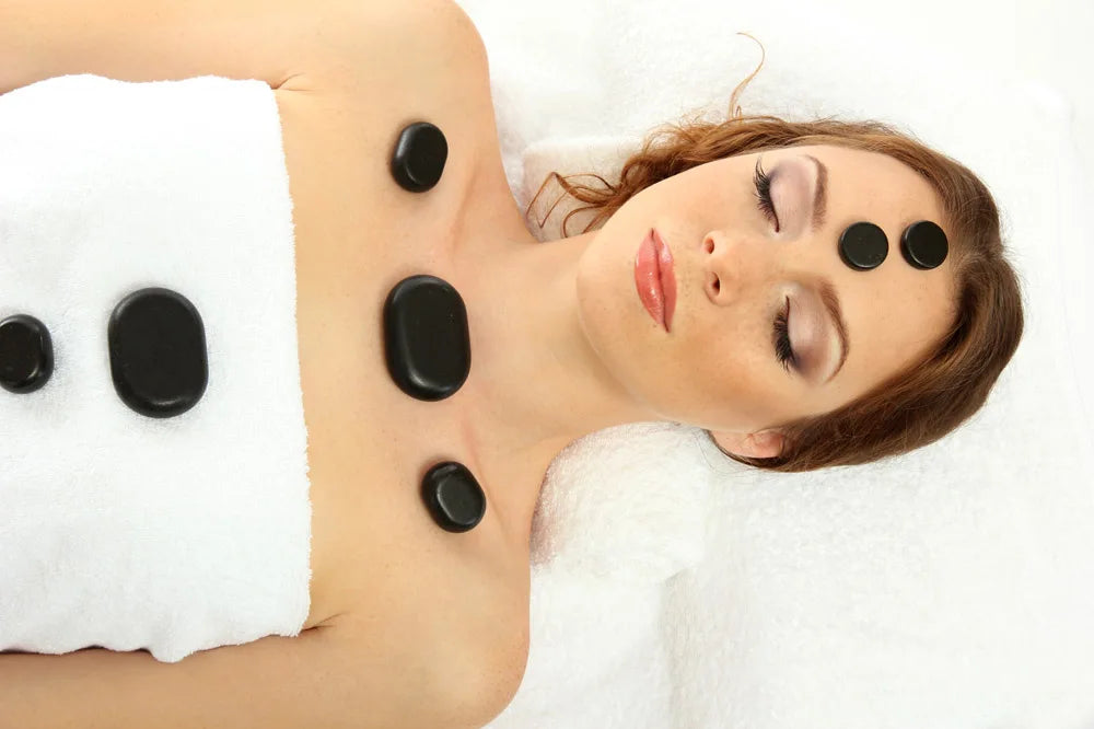 Massage therapy Jade Quarts Natural Stone set (10 Pieces 3 x 4 cm)  picture of a young woman with 2 stones on her forehead, 3 on her clavicle, and 2 others on her chest shown