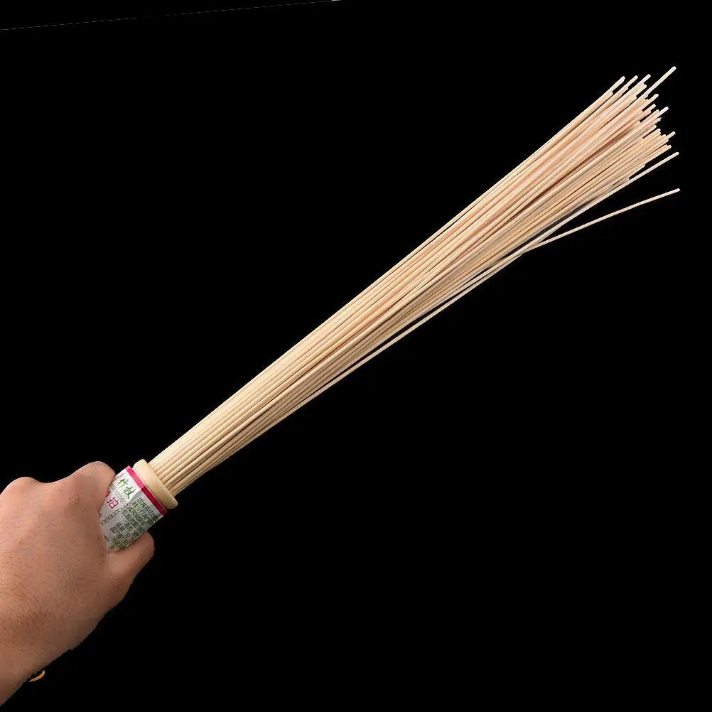 Massage therapy Natural Bamboo Massager 56 cm long held in a man's hand