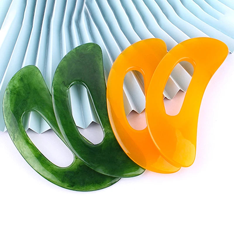 Massage Therapy Natural Stone Massagers Tools for body, neck, head and back Picture of 2 green colour massager and 2 orange one over a ligth green carton
