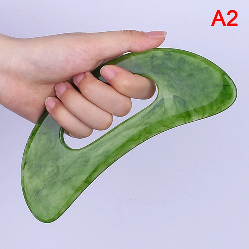 Massage Therapy Natural Stone Massagers Tools.  Picture of a green curve tool sizes : 18 cm X 6 cm (hole in middle to be able to grab it) held by a woman left-hand Model A2