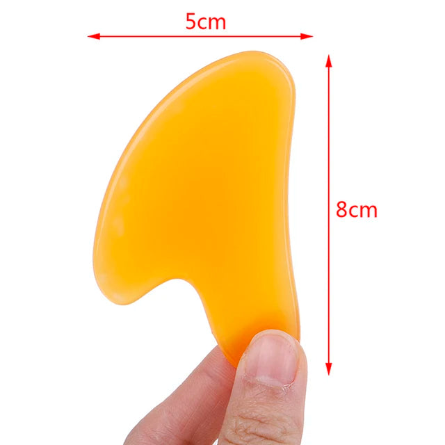 Massage Therapy Natural Stone Massagers Tools.  Picture of a yellow curve tool sizes : 8 cm X 5 cm held by a man left hand