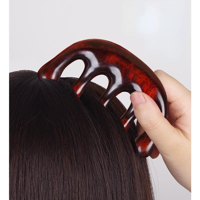 Massage Therapy Natural Wooden Massager Comb. Picture show the comb use by a woman in her dark hair