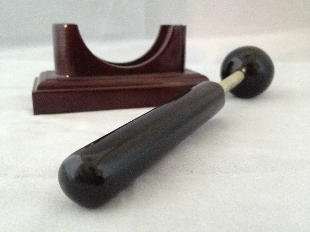 Massage therapy Sphere Black Jade Stone Hammer Tool in front of its base