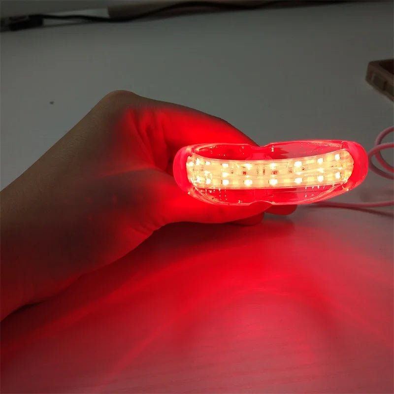 Personal health care red light therapy device held in a woman's hand picture