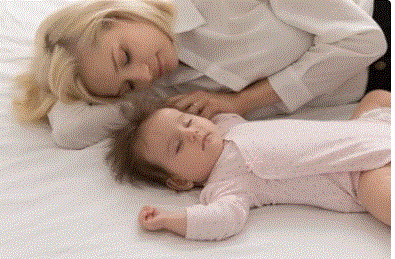 Free Picture of a mother co-sleeping with her baby - Blog: Discover safe co-sleeping tips, risks, benefits, and SIDS guidance.