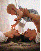 Free picture of parents playing with their baby - Blog: Understanding Your Baby: Communication & Care Tips