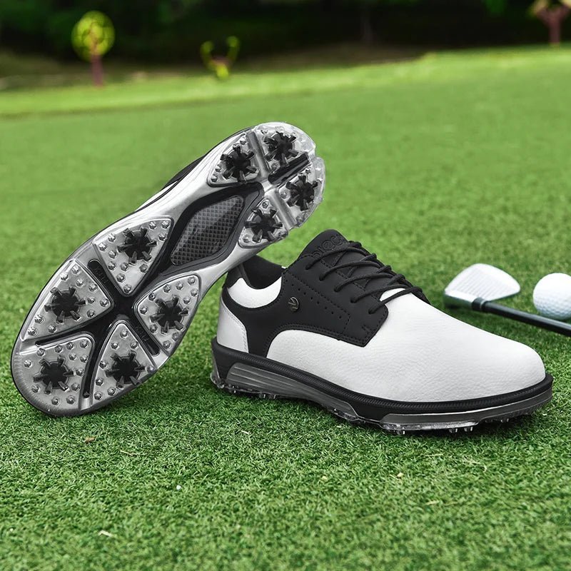 Golf Supplies & Equipment Golf Shoes Waterproof Non Slip. This picture show a pair of white and black colour shoes, one on top of the other, lie on closely mown grass golf green. The studded sole of one of the shoes is visible. A golf club and one golf ball are located behind it.