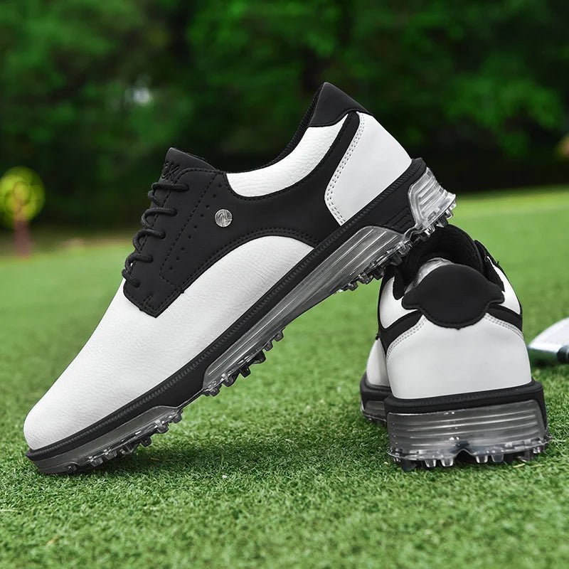 Golf Supplies & Equipment Golf Shoes Waterproof Non Slip. This picture show a pair of white and black colour shoes, one on top of the other, lie on closely mown grass of a golf course green. 
