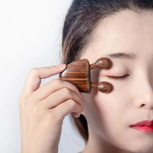 Jem Massage therapy:  A Woman using the wooden comb near the eye skin picture