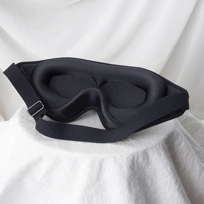 Jem Wellness Collection Soft 3D Sleep Mask for Light Blocking and Comfortable Rest Black Colour Offers shown Placed on a bed sheet