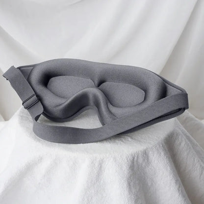Jem Wellness Collection Soft 3D Sleep Mask for Light Blocking and Comfortable Rest gray Colour Offers shown Placed on a bed sheet
