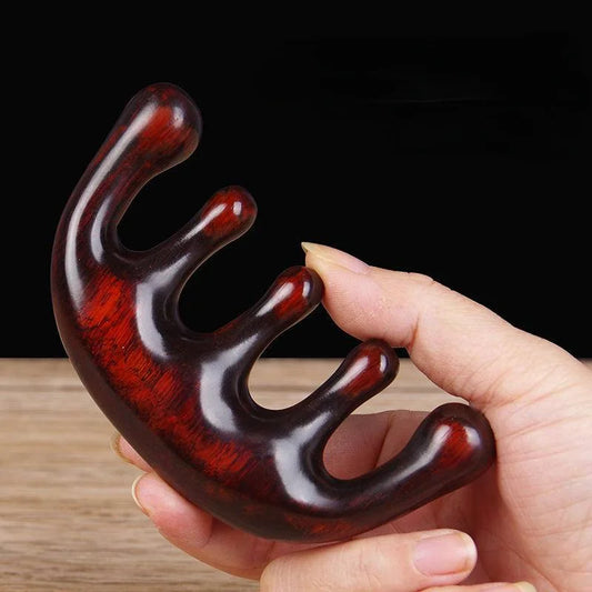 Massage Therapy Natural Wooden Massager Comb show in a woman hand with a white wood table in background