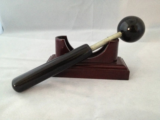 Massage therapy Sphere Black Jade Stone Hammer Tool leaning on its base