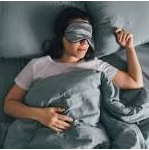 Personal Health Care, Picture of a woman sleeping in her bed with an eye mask, Blog: How to improve the quality of your sleep?