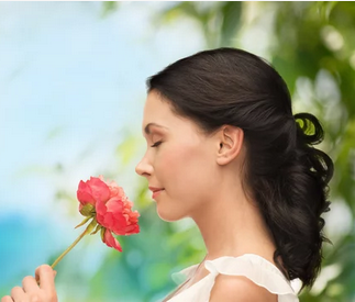 Personal Health Care, Picture of a young woman with black hair smelling roses flower, Blog: How to recover or improve your sense of smell?
