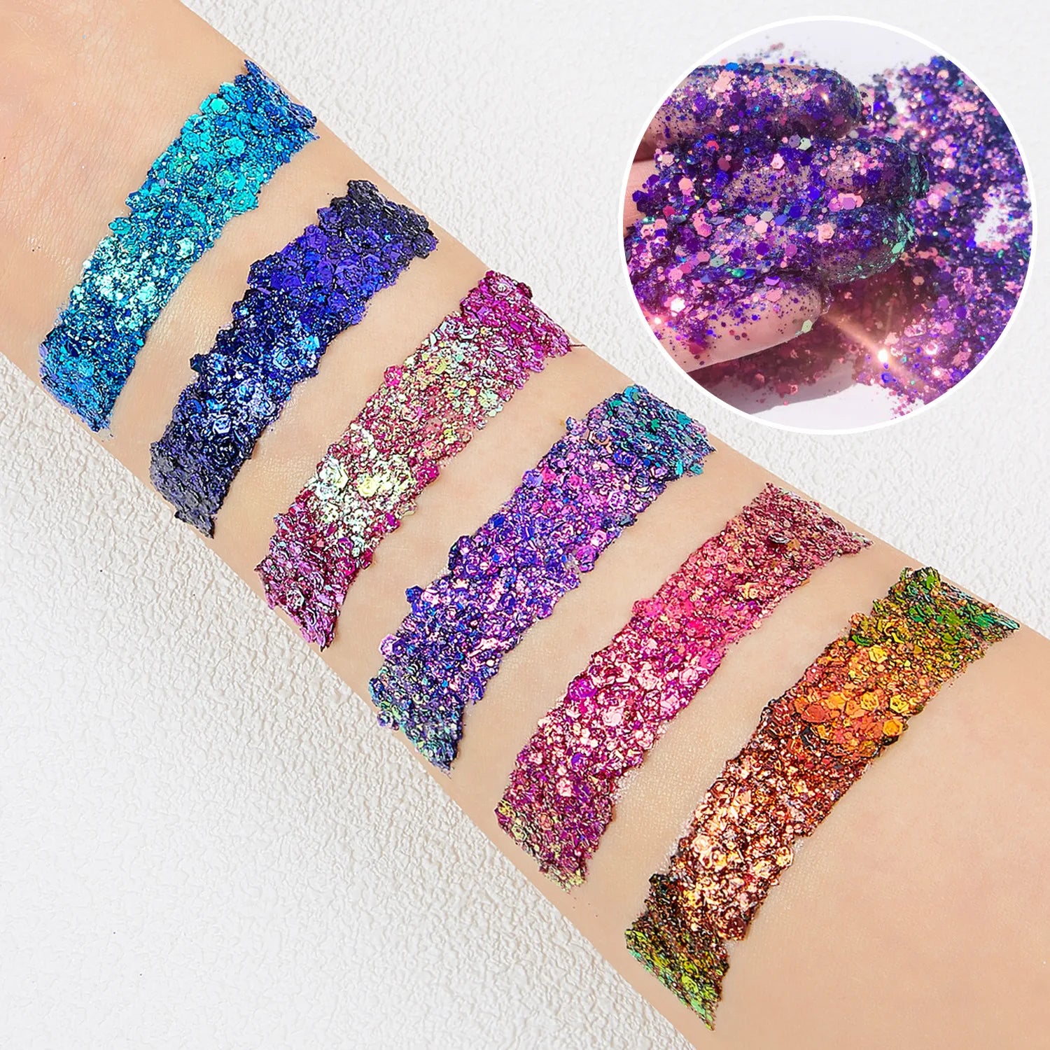 Wellness Chunky Glitter Eyeshadow Palette. Picture of 6 strips of colour applied to the skin of a young girl's arm (green, blue, red, purple, pink, orange)