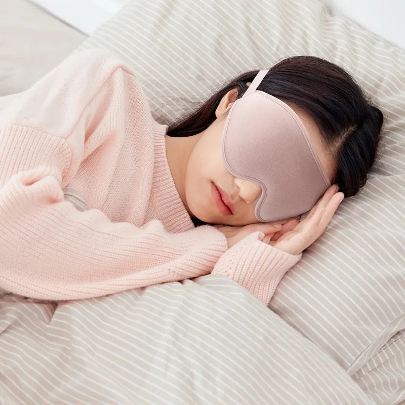 Jem Wellness Collection Soft 3D Sleep Mask for Light Blocking and Comfortable Rest Pink Colour Offers shown Used by a woman sleeping lying on her bed